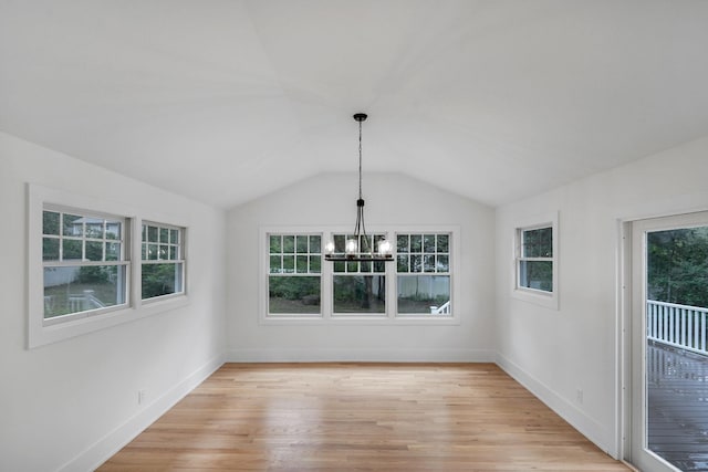 3 Thomas Dr, Wading River, NY 11792 - unfurnished dining area featuring a chandelier, light wood finished floors, vaulted ceiling, and baseboards