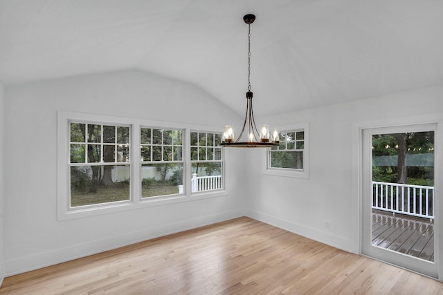 3 Thomas Dr, Wading River, NY 11792 - unfurnished dining area with a chandelier, healthy amount of natural light, lofted ceiling, baseboards, and wood finished floors