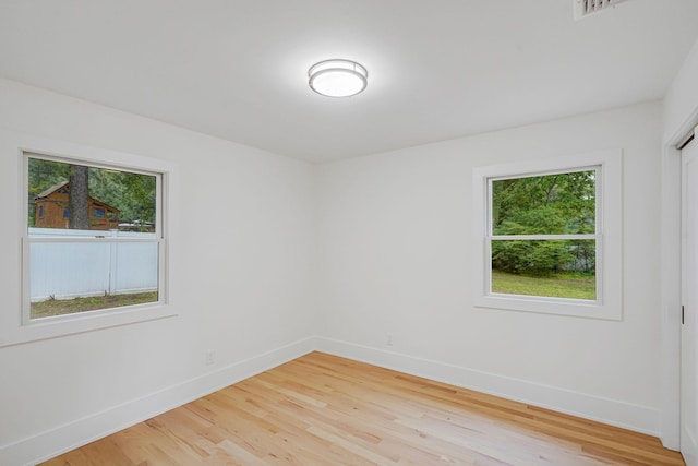 3 Thomas Dr, Wading River, NY 11792 - empty room with plenty of natural light, baseboards, and light wood-style flooring