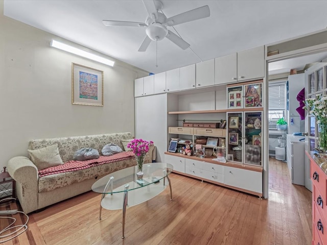 living area with ceiling fan and light wood-style floors
