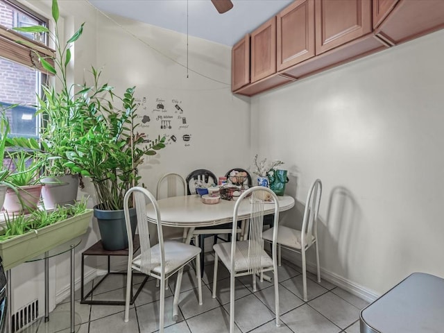 dining area featuring light tile patterned flooring, baseboards, and ceiling fan