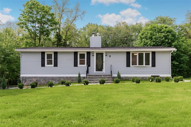 3 Idlewild Dr, Hyde Park, NY 12601 - view of front of house with a chimney, a front yard, and view of wooded area