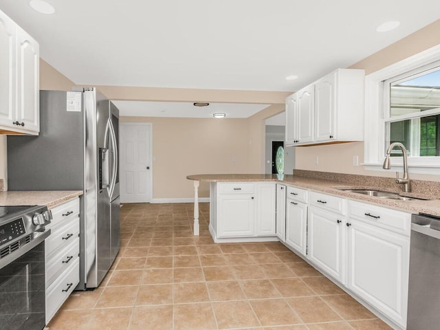 3 Idlewild Dr, Hyde Park, NY 12601 - kitchen featuring a sink, appliances with stainless steel finishes, white cabinets, a peninsula, and light stone countertops