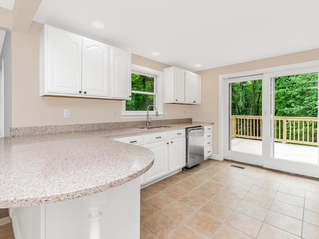 3 Idlewild Dr, Hyde Park, NY 12601 - kitchen featuring a sink, dishwasher, white cabinets, a peninsula, and light tile patterned floors