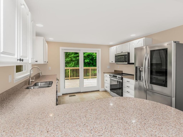3 Idlewild Dr, Hyde Park, NY 12601 - kitchen featuring stainless steel appliances, a sink, light stone countertops, white cabinets, and recessed lighting