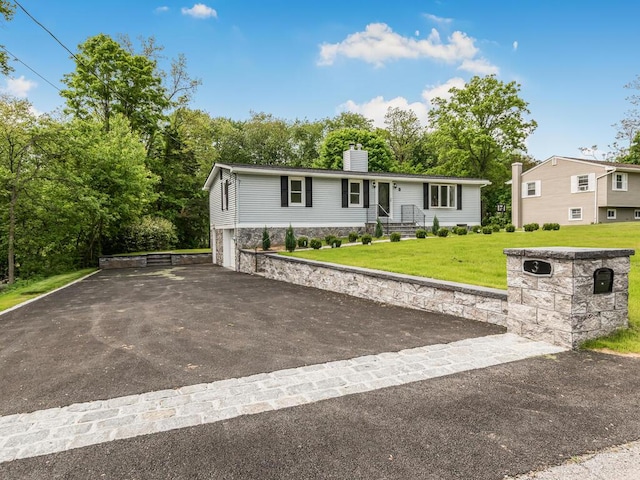 3 Idlewild Dr, Hyde Park, NY 12601 - view of front of home featuring driveway, a chimney, a garage, and a front yard