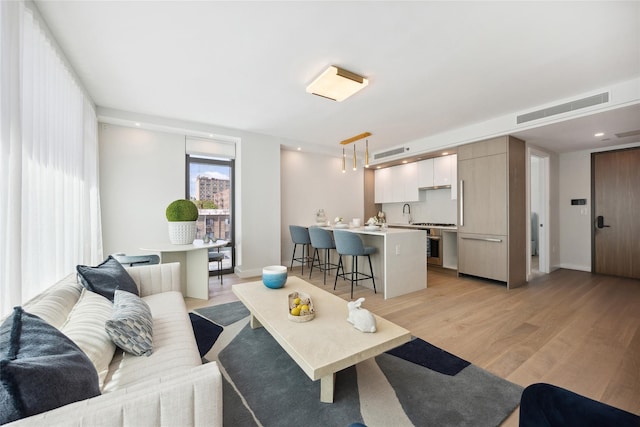 living area with light wood-style floors and baseboards