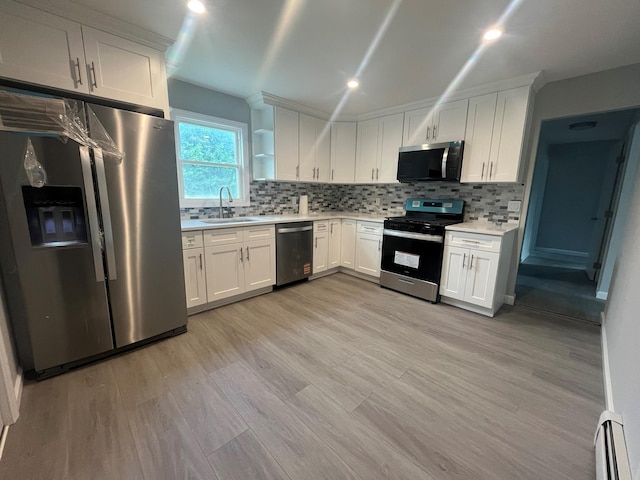 57 Doud St, Farmingdale, NY 11735 - kitchen featuring appliances with stainless steel finishes, a sink, light countertops, light wood-type flooring, and a baseboard radiator