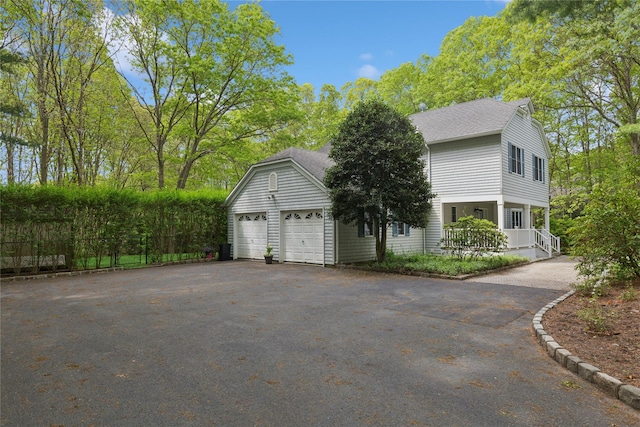 6 Carriage Path, Manorville, NY 11949 - view of side of property featuring asphalt driveway, roof with shingles, and fence