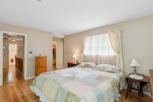 6 Carriage Path, Manorville, NY 11949 - bedroom featuring light wood finished floors, multiple windows, and baseboards