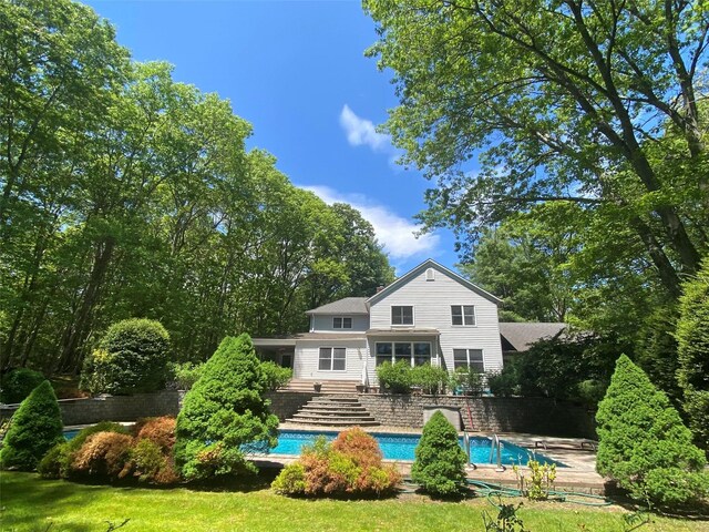 6 Carriage Path, Manorville, NY 11949 - rear view of property with an outdoor pool and a lawn