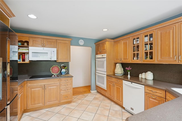 6 Carriage Path, Manorville, NY 11949 - kitchen with white appliances, dark countertops, decorative backsplash, light tile patterned flooring, and glass insert cabinets