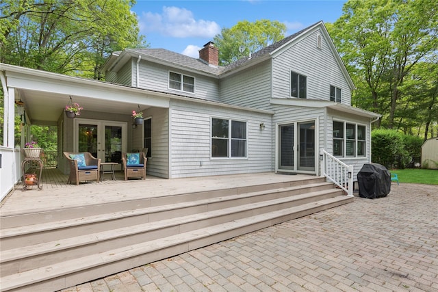 6 Carriage Path, Manorville, NY 11949 - back of house featuring a chimney, a wooden deck, a patio, and french doors