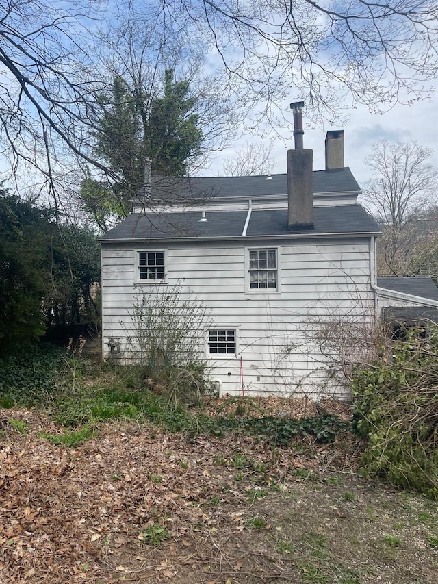 view of property exterior with a chimney