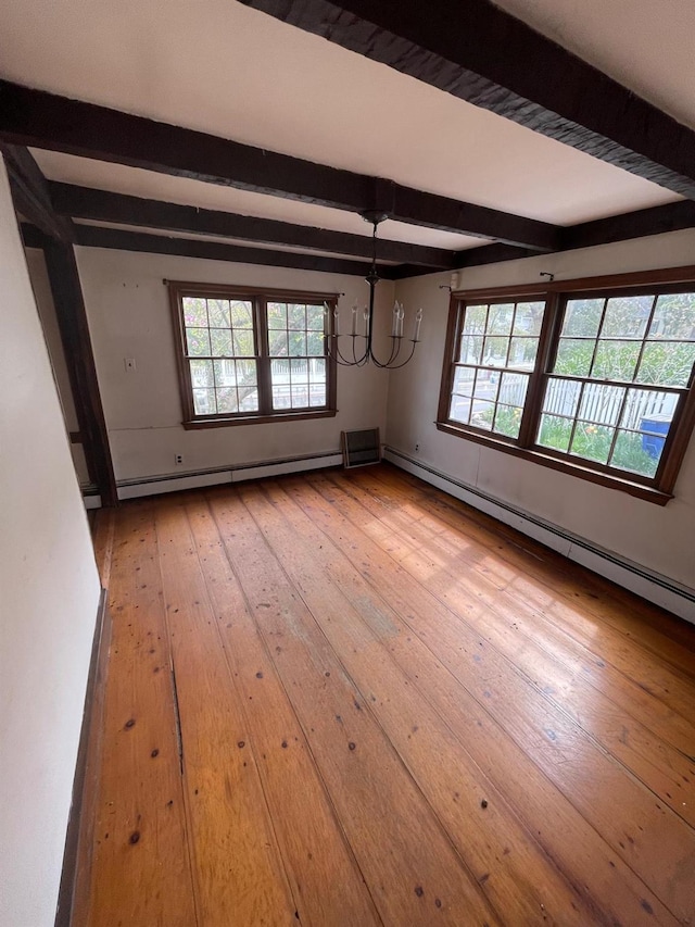 unfurnished room featuring a baseboard radiator, beamed ceiling, light wood-style flooring, and plenty of natural light