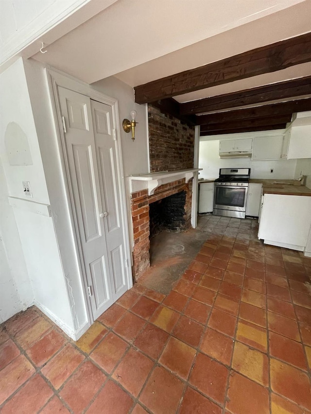 unfurnished living room with a brick fireplace and beamed ceiling