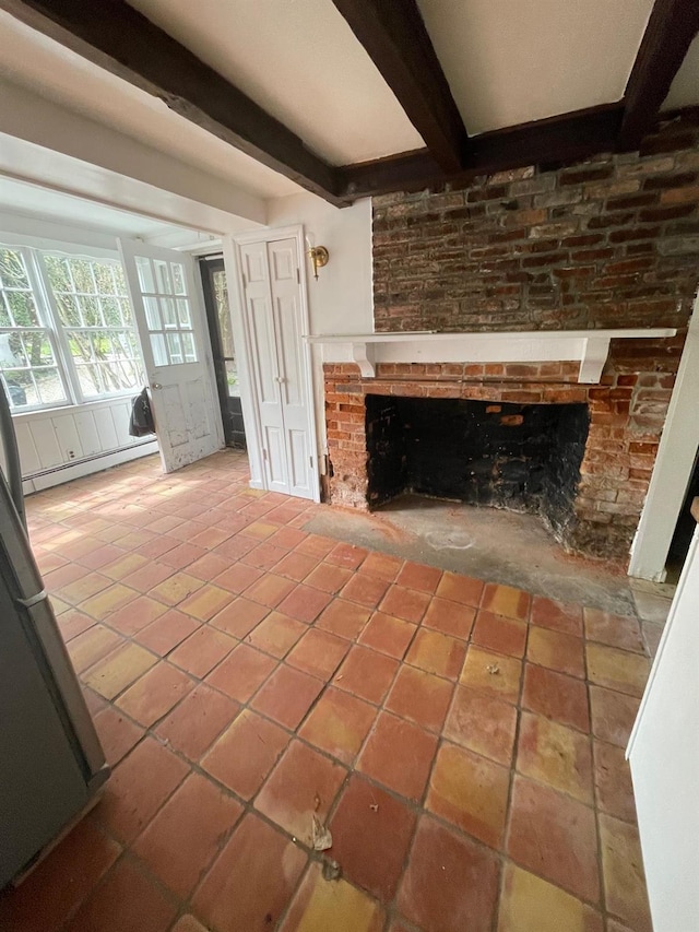 unfurnished living room featuring a baseboard heating unit, beamed ceiling, a brick fireplace, and tile patterned flooring
