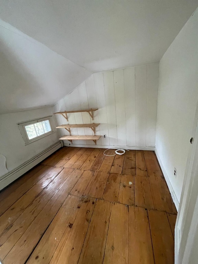 bonus room featuring wood-type flooring and vaulted ceiling