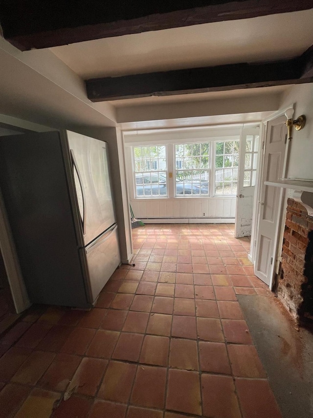 kitchen with freestanding refrigerator, tile patterned flooring, and beam ceiling