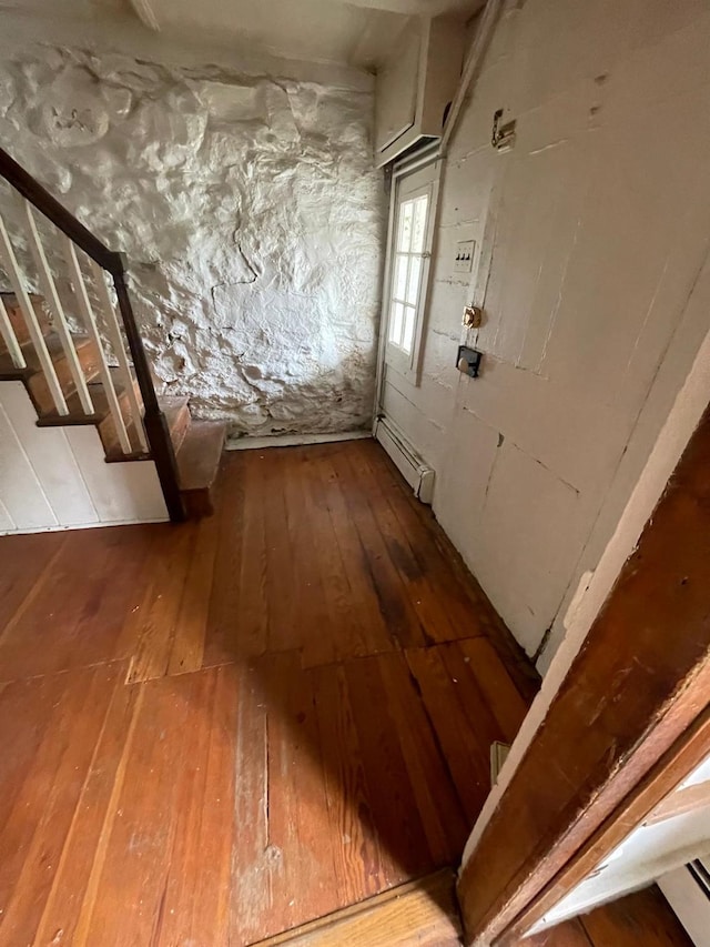 hall featuring wood-type flooring and a baseboard radiator