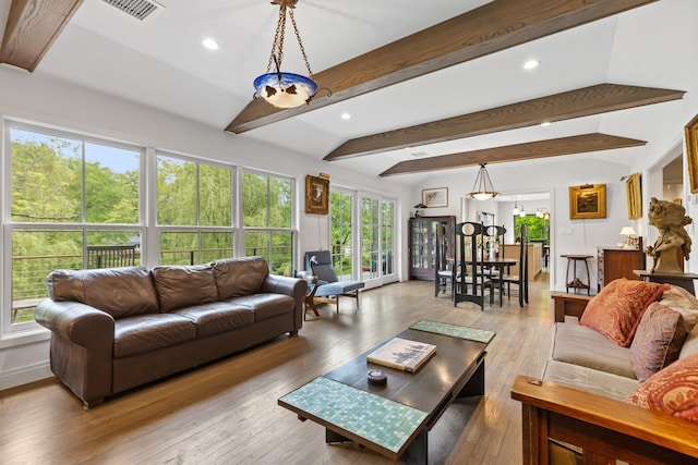 living room with hardwood / wood-style flooring, recessed lighting, and beam ceiling