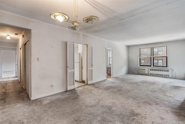 102-30 Queens Blvd Unit 3R, Forest Hills, NY 11375 - unfurnished living room with radiator heating unit, carpet, and a wall mounted AC