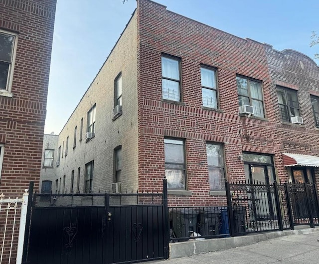 1705 E 174th Sts, Bronx, NY 10472 - view of building exterior featuring a fenced front yard and cooling unit