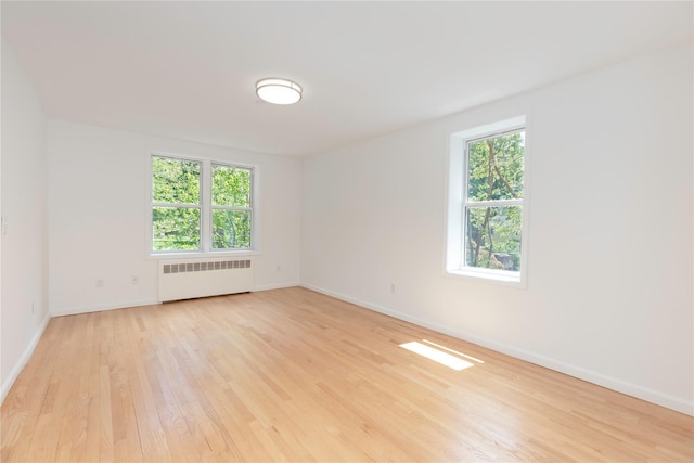 1 Hawley Ter Unit 5E, Yonkers, NY 10701 - unfurnished room with radiator heating unit, light wood-style floors, plenty of natural light, and baseboards