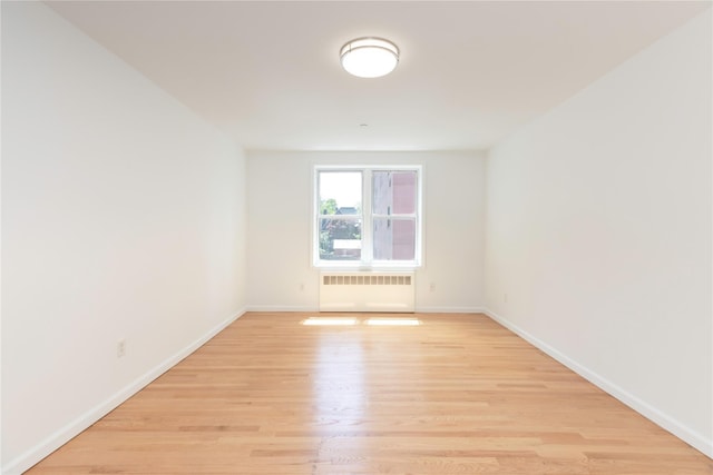 1 Hawley Ter Unit 5E, Yonkers, NY 10701 - unfurnished room with radiator, light wood-style floors, and baseboards