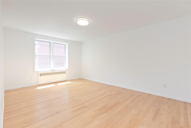1 Hawley Ter Unit 5E, Yonkers, NY 10701 - unfurnished room featuring radiator heating unit, baseboards, and light wood finished floors