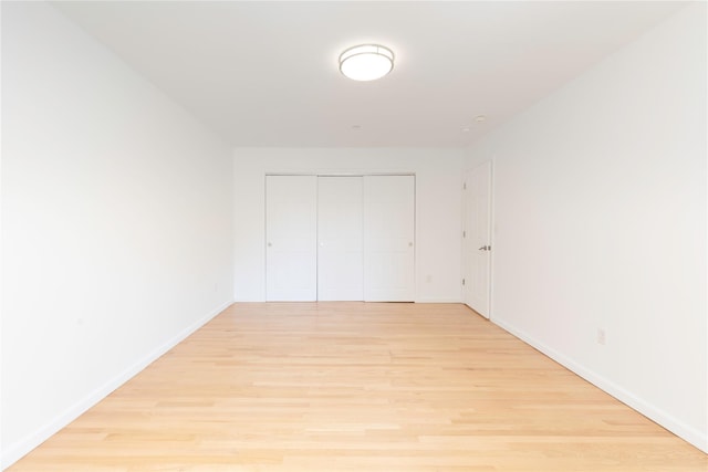 1 Hawley Ter Unit 5E, Yonkers, NY 10701 - unfurnished bedroom featuring light wood-type flooring, baseboards, and a closet