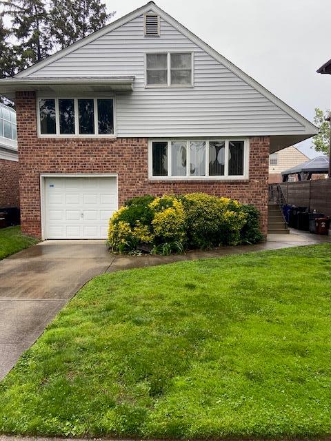 16615 67th Ave, Fresh Meadows, NY 11365 - tri-level home featuring brick siding, a garage, concrete driveway, and a front lawn