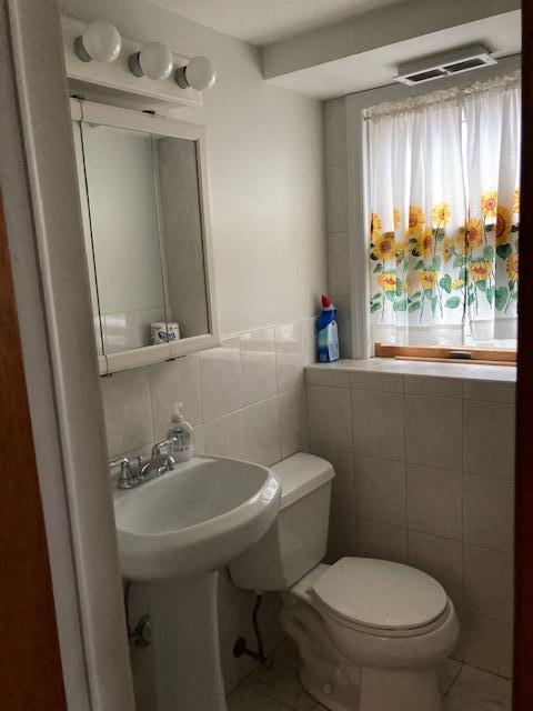 16615 67th Ave, Fresh Meadows, NY 11365 - bathroom with toilet, tile walls, and tile patterned flooring