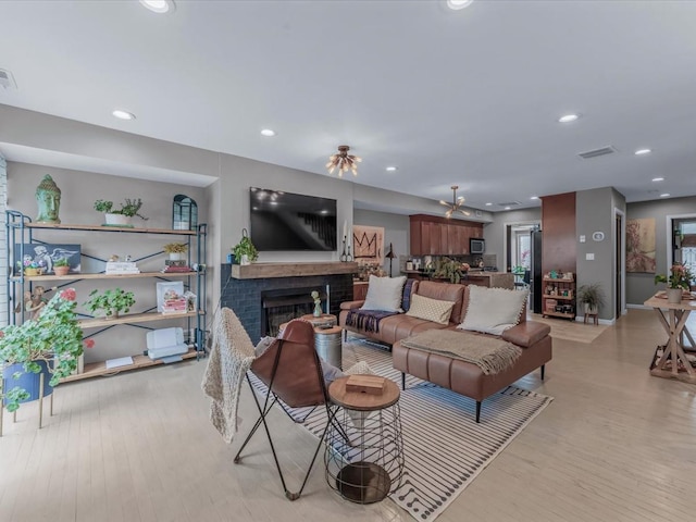 12 Deepwater Way Unit 31, Bronx, NY 10464 - living room with light wood-style floors, a fireplace, recessed lighting, and baseboards