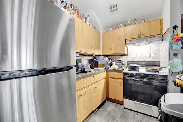 303 Howe Ave, Bronx, NY 10473 - kitchen featuring freestanding refrigerator, range with gas cooktop, under cabinet range hood, backsplash, and light brown cabinetry