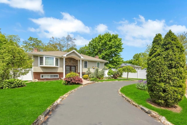 25 Terrace View Rd, Farmingdale, NY 11735 - raised ranch with a chimney, brick siding, asphalt driveway, and french doors