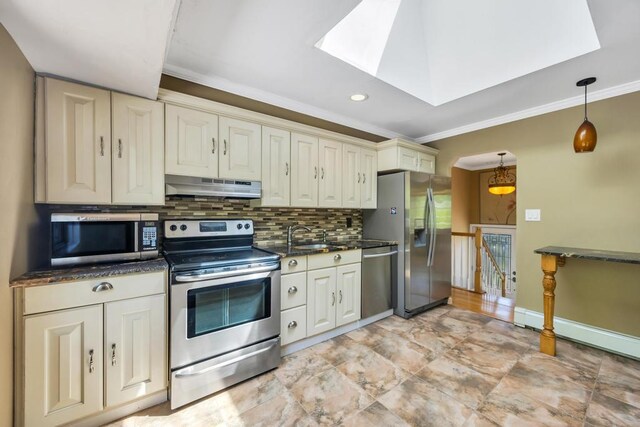 25 Terrace View Rd, Farmingdale, NY 11735 - kitchen with under cabinet range hood, stainless steel appliances, a skylight, crown molding, and decorative backsplash