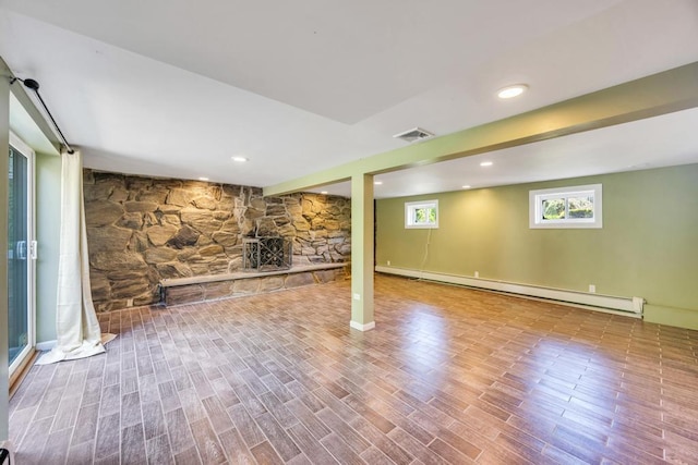 25 Terrace View Rd, Farmingdale, NY 11735 - below grade area featuring a baseboard radiator, wood finished floors, and a fireplace