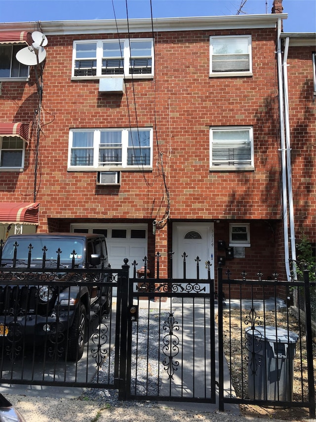 3314 Wickham Ave, Bronx, NY 10469 - multi unit property featuring a garage, a fenced front yard, and brick siding