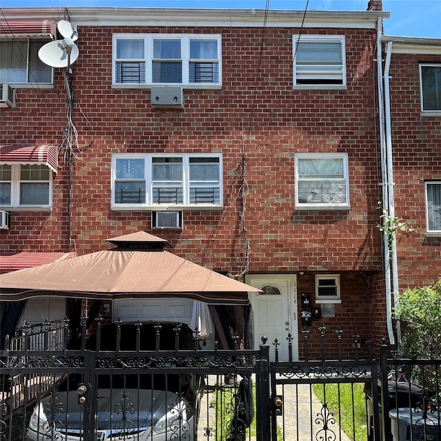 3314 Wickham Ave, Bronx, NY 10469 - view of property featuring a fenced front yard, brick siding, and a gate