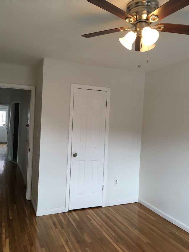 3314 Wickham Ave, Bronx, NY 10469 - unfurnished bedroom featuring dark wood-style floors, baseboards, and ceiling fan