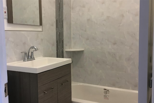 3314 Wickham Ave, Bronx, NY 10469 - full bathroom featuring vanity, shower / tub combination, and tile walls