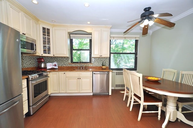 67 Rockledge Rd Unit 2A, Hartsdale, NY 10530 - kitchen with stainless steel appliances, ornamental molding, decorative backsplash, a ceiling fan, and radiator heating unit