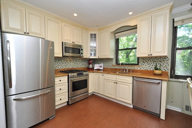 67 Rockledge Rd Unit 2A, Hartsdale, NY 10530 - kitchen with stainless steel appliances, cream cabinets, dark wood-style flooring, a sink, and recessed lighting