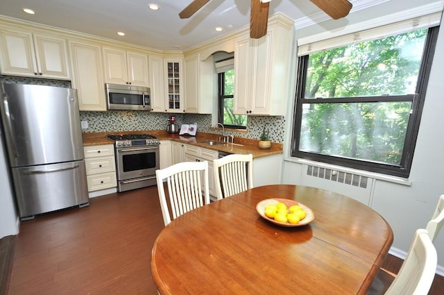 67 Rockledge Rd Unit 2A, Hartsdale, NY 10530 - kitchen with appliances with stainless steel finishes, radiator, ceiling fan, a sink, and cream cabinets