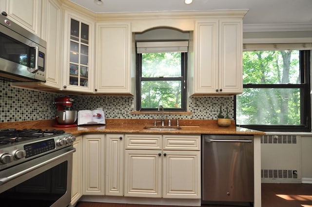 67 Rockledge Rd Unit 2A, Hartsdale, NY 10530 - kitchen featuring stainless steel appliances, a sink, radiator heating unit, tasteful backsplash, and crown molding