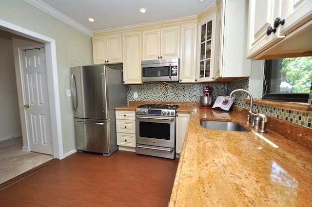 67 Rockledge Rd Unit 2A, Hartsdale, NY 10530 - kitchen featuring stainless steel appliances, cream cabinetry, a sink, decorative backsplash, and glass insert cabinets