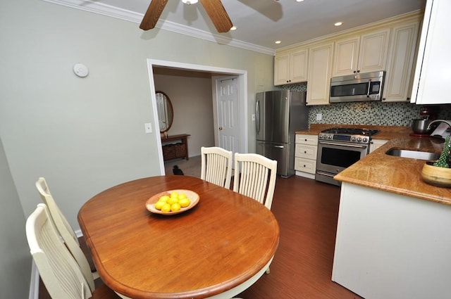 67 Rockledge Rd Unit 2A, Hartsdale, NY 10530 - kitchen featuring appliances with stainless steel finishes, cream cabinetry, a sink, crown molding, and backsplash