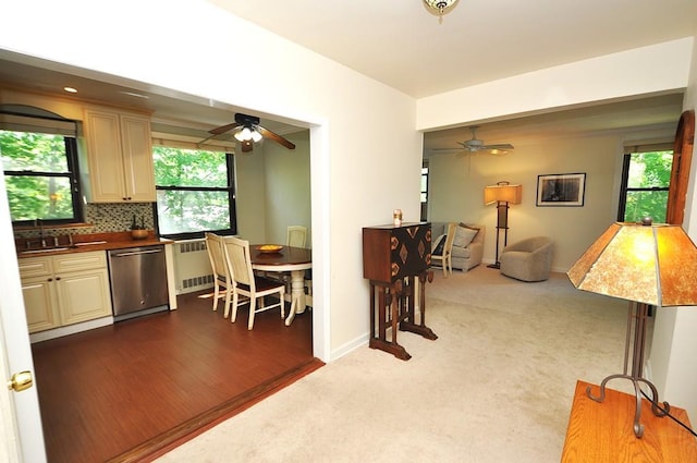 67 Rockledge Rd Unit 2A, Hartsdale, NY 10530 - kitchen with stainless steel dishwasher, ceiling fan, cream cabinetry, a sink, and dark colored carpet