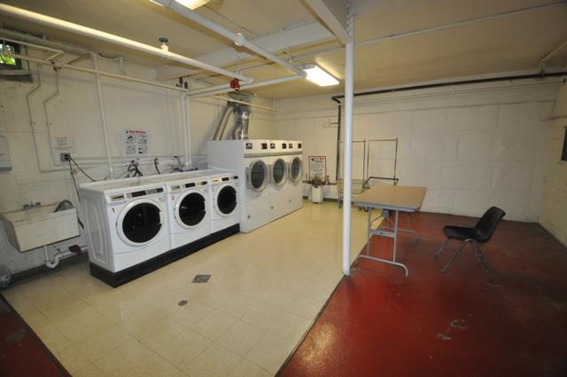 67 Rockledge Rd Unit 2A, Hartsdale, NY 10530 - community laundry featuring washer and dryer, concrete block wall, and a garage
